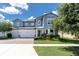 Charming two-story home with a three-car garage, brick driveway, and professionally landscaped yard at 2641 Whittler Br, Odessa, FL 33556