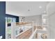 Open hallway featuring wood floors and a modern cable railing with a view to the downstairs living space at 2641 Whittler Br, Odessa, FL 33556