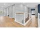 Open hallway with wood floors, horizontal bar railing, and a view to the exterior at 2641 Whittler Br, Odessa, FL 33556