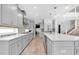 Long kitchen features sleek appliances, grey cabinets, and designer backsplash at 2641 Whittler Br, Odessa, FL 33556