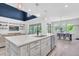 Open-concept kitchen with a spacious island, stainless steel appliances, and an adjacent dining area at 2641 Whittler Br, Odessa, FL 33556