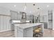 Well-lit kitchen features a large island, modern cabinetry, and stainless steel appliances at 2641 Whittler Br, Odessa, FL 33556