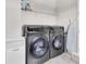Modern laundry room with front load washer and dryer plus wire shelving at 2641 Whittler Br, Odessa, FL 33556
