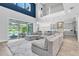 Bright living room featuring a large sectional, access to a pool and open to the kitchen at 2641 Whittler Br, Odessa, FL 33556