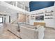 Spacious living room with high ceilings, decorative shelves, and an open staircase at 2641 Whittler Br, Odessa, FL 33556