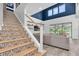 View of the open-concept living room with tile stairs and high, decorative ceilings at 2641 Whittler Br, Odessa, FL 33556