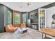 Modern living room with comfortable seating, decor, and access to the exterior at 2641 Whittler Br, Odessa, FL 33556