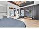 Bright main bedroom featuring a wet bar, statement lighting, workout area, and adjacent office at 2641 Whittler Br, Odessa, FL 33556