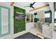 Well-appointed outdoor kitchen with a built-in grill, bar, and integrated television at 2641 Whittler Br, Odessa, FL 33556