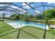 Beautiful pool and spa area featuring lush landscaping and a screened enclosure at 2641 Whittler Br, Odessa, FL 33556