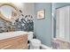 Chic powder room with unique scallop wall tiles, wood vanity, and gold fixtures at 2641 Whittler Br, Odessa, FL 33556