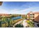 Scenic aerial view of beautiful landscaping, walking path and buildings with tile roofs by a lake at 2722 Via Tivoli # 430A, Clearwater, FL 33764