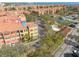 Aerial view of a residential complex, showcasing the buildings, parking areas, tennis court, and surrounding greenery at 2722 Via Tivoli # 430A, Clearwater, FL 33764