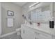 Well-lit bathroom featuring a marble vanity, a decorative mirror, and modern fixtures at 2722 Via Tivoli # 430A, Clearwater, FL 33764