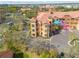 Aerial view of a multi-story residential building with a Mediterranean-style design and lush landscaping at 2722 Via Tivoli # 430A, Clearwater, FL 33764