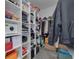 Walk-in closet with ample shelving and hanging space for clothing and accessories, plus a safe at 2722 Via Tivoli # 430A, Clearwater, FL 33764