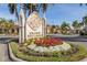 Grand Bellagio community sign surrounded by vibrant flowers and lush landscaping in a picturesque setting at 2722 Via Tivoli # 430A, Clearwater, FL 33764