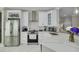 A contemporary kitchen with stainless steel appliances and a marble countertop island at 2722 Via Tivoli # 430A, Clearwater, FL 33764