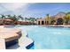 Resort-style pool featuring multiple sunning stations, palm trees and cabanas for a luxury experience at 2722 Via Tivoli # 430A, Clearwater, FL 33764