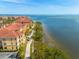 Scenic waterfront view of buildings, a walkway, and the ocean, with a bridge visible in the distance at 2722 Via Tivoli # 430A, Clearwater, FL 33764