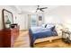 Bedroom with natural light, wood floors, side table, and a large dresser at 2969 Bonaventure Cir # 104, Palm Harbor, FL 34684