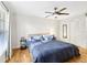 Bedroom featuring a large bed, ceiling fan, natural light, wood floors, and neutral tones at 2969 Bonaventure Cir # 104, Palm Harbor, FL 34684