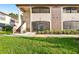 Inviting condo with a well-manicured lawn and attractive architectural details at 2969 Bonaventure Cir # 104, Palm Harbor, FL 34684
