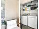 Laundry room with full size washer and dryer, seating area, and a storage at 2969 Bonaventure Cir # 104, Palm Harbor, FL 34684