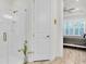 Shower room featuring a glass door, subway tile surround, and view to the bedroom with plantation shutters at 3166 Francoa Dr, Odessa, FL 33556