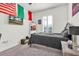 Comfortable bedroom featuring a bed, decorative flags, and a wall-mounted television at 3166 Francoa Dr, Odessa, FL 33556