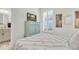 Bedroom with shuttered window and an entertainment center featuring a wall-mounted television at 3166 Francoa Dr, Odessa, FL 33556