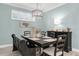 Elegant dining room with a large wooden table, comfortable seating, and a stylish chandelier at 3166 Francoa Dr, Odessa, FL 33556