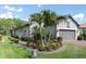 Charming home featuring manicured landscaping and a brick driveway leading to a two-car garage at 3166 Francoa Dr, Odessa, FL 33556