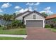 This home has a brick driveway leading to a 2-car garage and is surrounded by beautiful landscaping at 3166 Francoa Dr, Odessa, FL 33556