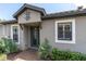 Charming home featuring an ornate front door, decorative windows, and lush tropical landscaping at 3166 Francoa Dr, Odessa, FL 33556