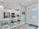 Bright kitchen featuring white cabinets, stainless steel appliances, and an island with bar stool seating at 3166 Francoa Dr, Odessa, FL 33556