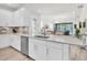 Spacious kitchen with white cabinetry, stainless steel appliances, granite countertops, and an open view to the living area at 3166 Francoa Dr, Odessa, FL 33556