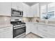 Modern kitchen with stainless steel appliances, granite countertops, tiled backsplash, and plenty of cabinet space at 3166 Francoa Dr, Odessa, FL 33556