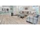 Open-concept living area with beachy decor, including light wood floors and white kitchen at 3166 Francoa Dr, Odessa, FL 33556