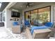 Comfortable outdoor patio area with wicker furniture, ceiling fan, and sliding glass doors at 3166 Francoa Dr, Odessa, FL 33556