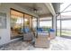 Relaxing outdoor patio area featuring wicker seating and a seamless transition to indoor living spaces at 3166 Francoa Dr, Odessa, FL 33556