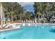 Resort-style pool surrounded by lounge chairs and lush landscaping, perfect for relaxation at 3166 Francoa Dr, Odessa, FL 33556