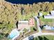 An aerial view of the community pool, outdoor dining area, and clubhouse by the lake at 3224 Hilary Cir, Palm Harbor, FL 34684