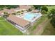 Aerial view of community pool and clubhouse; perfect for recreation and relaxation at 3224 Hilary Cir, Palm Harbor, FL 34684