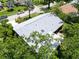 Overhead view showcasing a home with a new gray roof surrounded by lush trees in a quiet neighborhood at 3224 Hilary Cir, Palm Harbor, FL 34684
