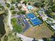 Community aerial with tennis courts, pool, clubhouse, parking, and scenic green landscaping at 3224 Hilary Cir, Palm Harbor, FL 34684