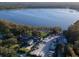 Aerial view of community with RV parking, lake access, and mature landscaping at 3224 Hilary Cir, Palm Harbor, FL 34684