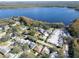 Stunning aerial view of lakeside homes with mature trees and boat parking along the shoreline at 3224 Hilary Cir, Palm Harbor, FL 34684