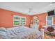 Bedroom with coral walls, tile floors, a ceiling fan and a large window with a view of the yard at 3224 Hilary Cir, Palm Harbor, FL 34684