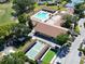 Aerial view of community with pool, shuffleboard, tennis courts, and club house at 3224 Hilary Cir, Palm Harbor, FL 34684
